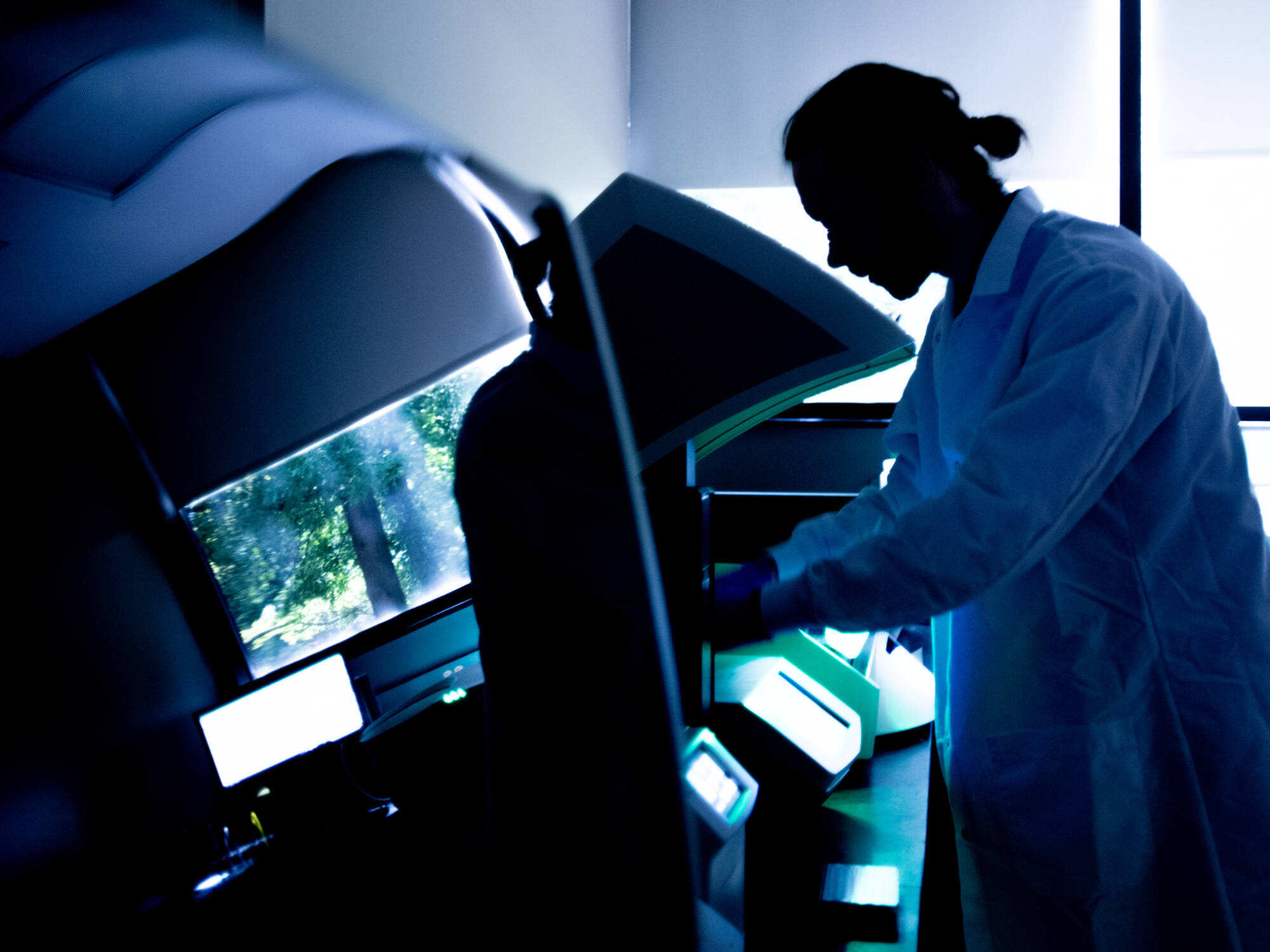 Austin Schian, manager of the Molecular Monitoring for Health and Environment Lab, carries out a complex laboratory process on the wastewater samples, using multiple instruments, as part of the final steps before the information is reported.